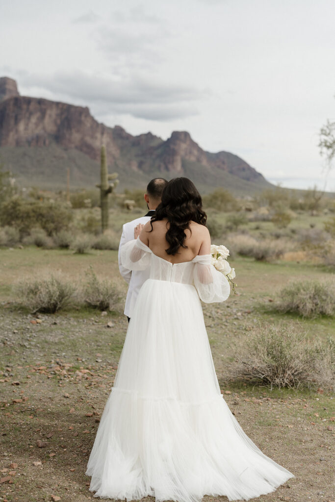 Bride and groom first look with Superstition Mountains in the background