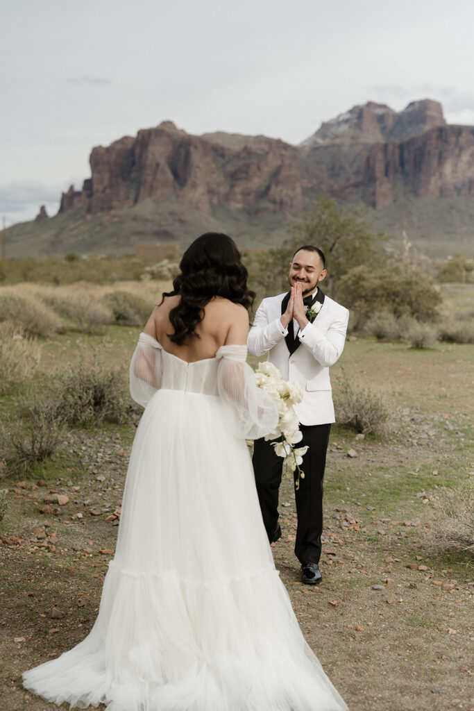 Bride and groom first look with Superstition Mountains in the background