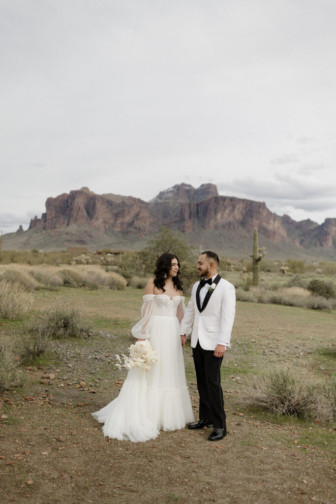 Bride and groom with Superstition Mountains in the background