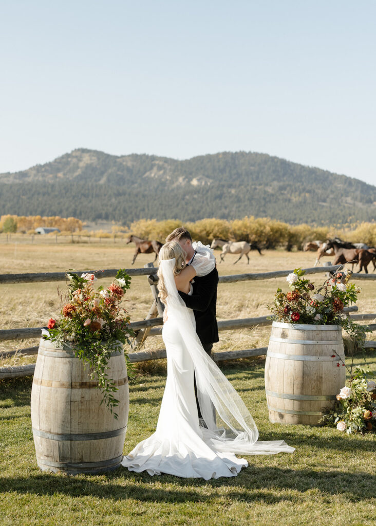 Diamond Cross Ranch wedding with horses in the background