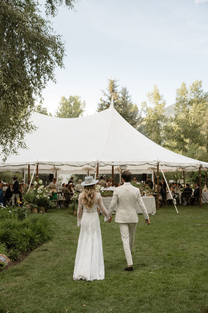 bride and groom head into their Coastal cowgirl inspired wedding reception