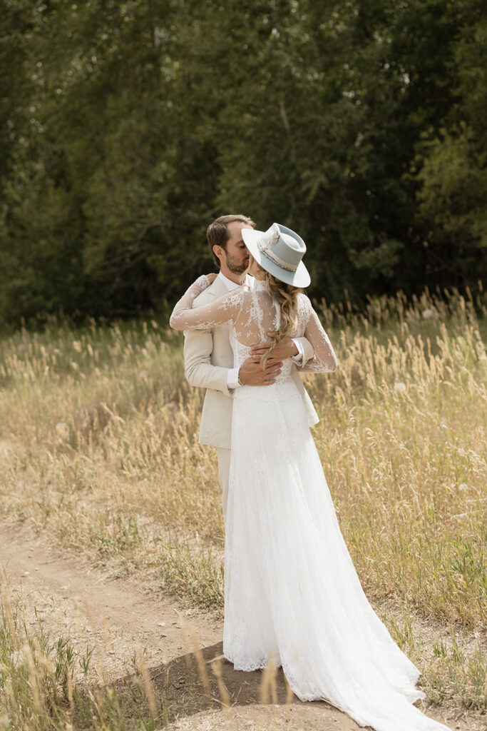 Coastal cowgirl inspired bride and groom photos in a field in Aspen