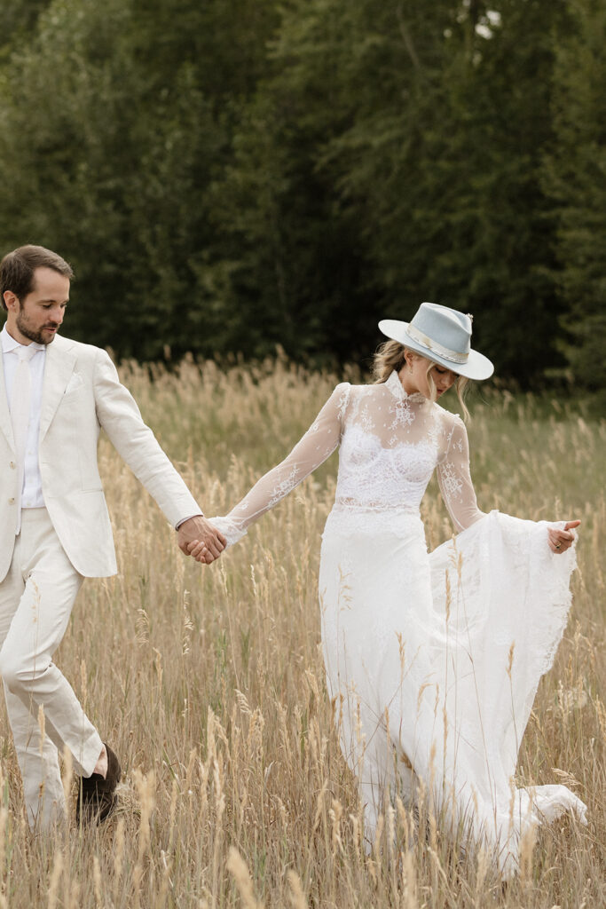 Coastal cowgirl inspired bride and groom photos in a field in Aspen