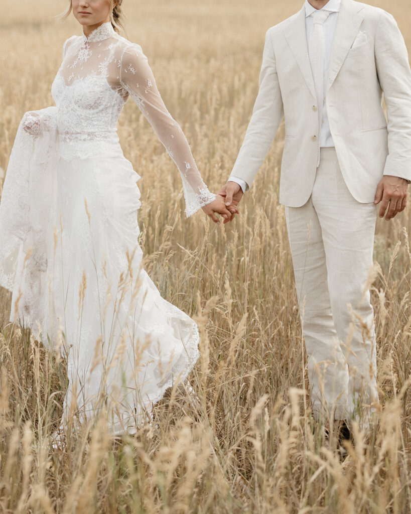 Coastal cowgirl inspired bride and groom photos in a field in Aspen
