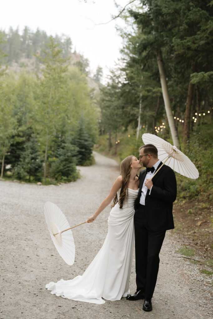 Wedding portraits in the forest with parasol umbrellas at Blackstone Rivers Ranch