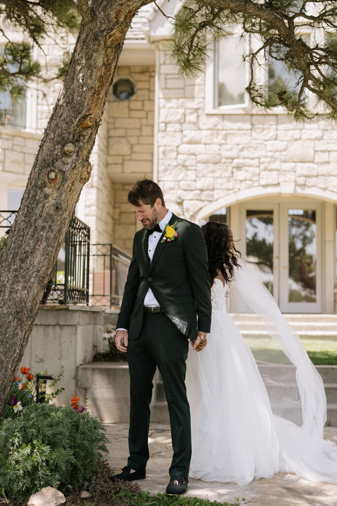 Bride and groom first touch at Greystone Castle in Boulder, Colorado