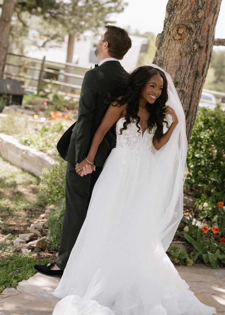 Bride and groom first touch at Greystone Castle in Boulder, Colorado