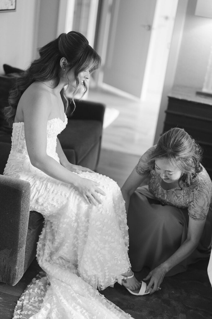 Bride's mother helps put her heels on at the Grand Hyatt in Vail