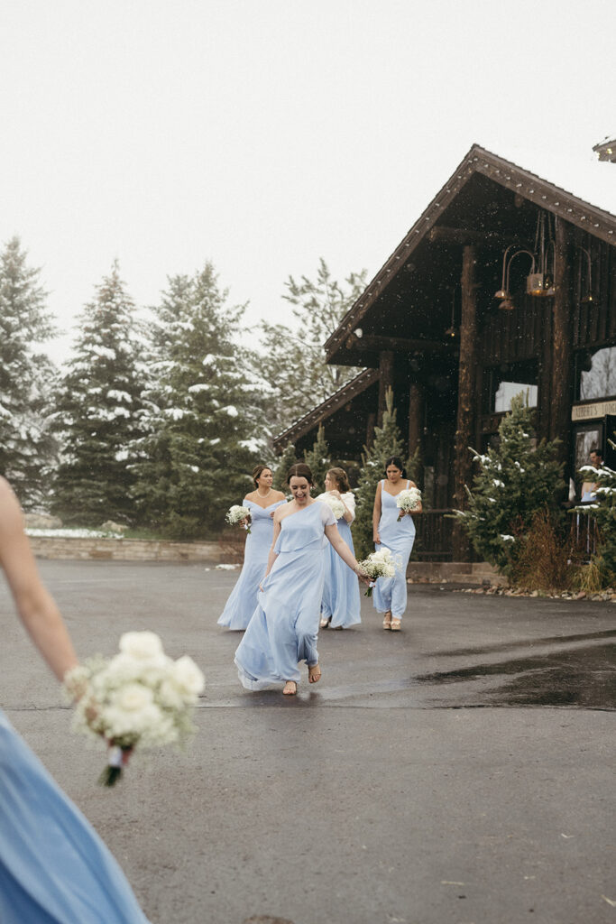 Bridesmaids walk to the Colorado winter wedding ceremony