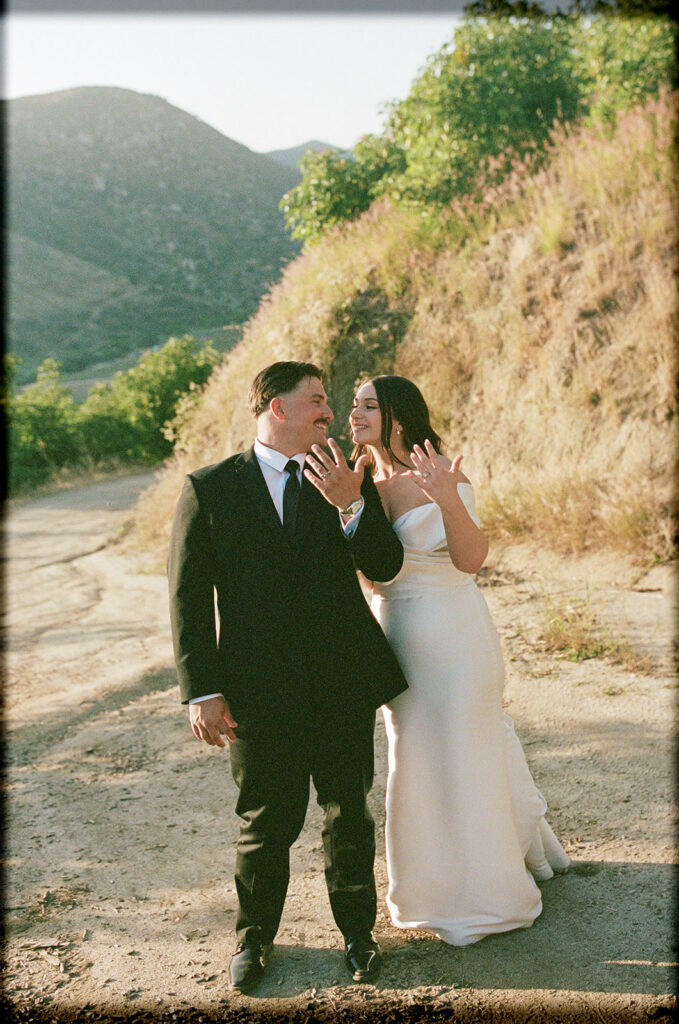 Rancho Guejito bride and groom showing their rings on 35mm film