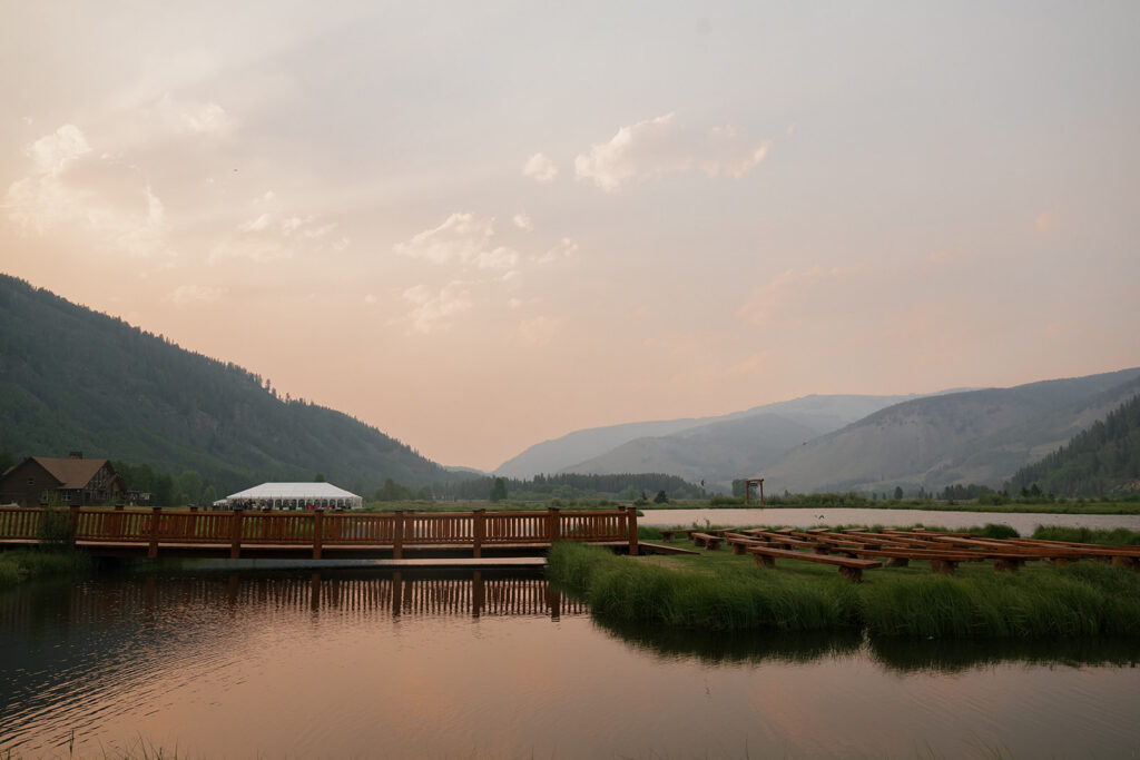 View of the Camp Hale wedding ceremony and reception spaces with mountains in the backdrop