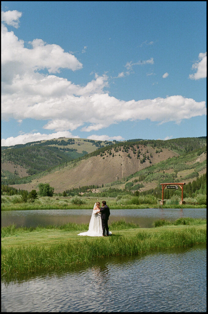 Bride and groom with Colorado mountains in the backdrop