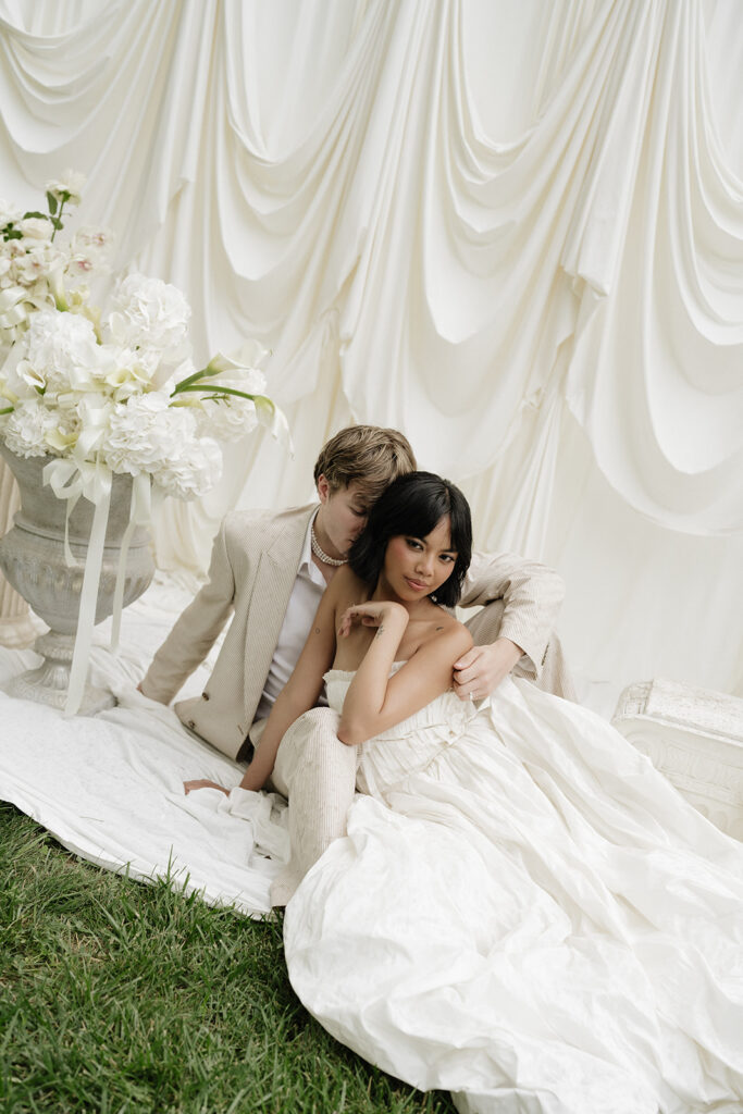 Bride and groom in front of a draped backdrop at a wedding venue near Boulder, Colorado: Burning Sky Farm